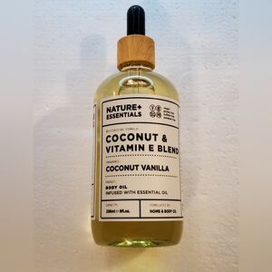 New Nature+ Essentials Coconut & Vitamin E Body Oil with a Coconut Vanilla Scent